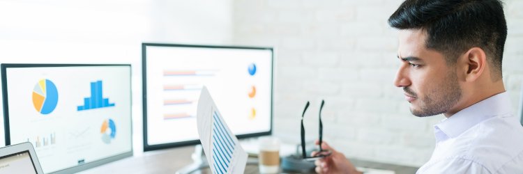 Data analyst looking at data on his computer