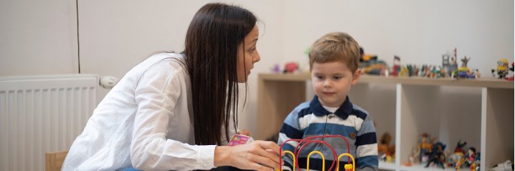 Applied behavior analyst working with a young child