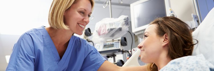 Adult-Gerontology Acute Care Nurse Practitioner talking to a patient in the hospital