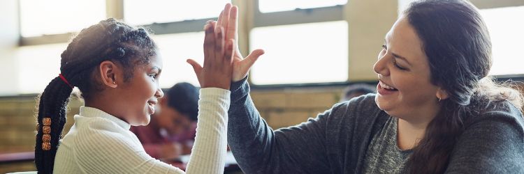 Teacher working with a student who has autism spectrium disorder in a classroom