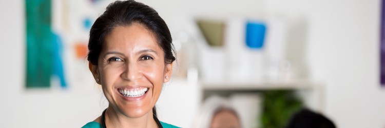 Nurse practitioner smiling before entering a meeting