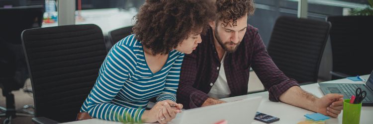 Two marketing professionals looking at a social media campaign