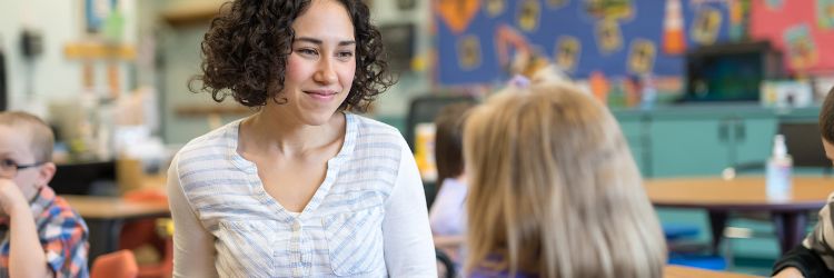 Special education teacher working with students in a classroom