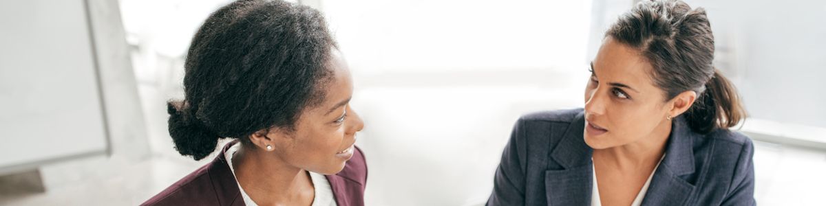 Two health communication specialists discussing an issue in an office