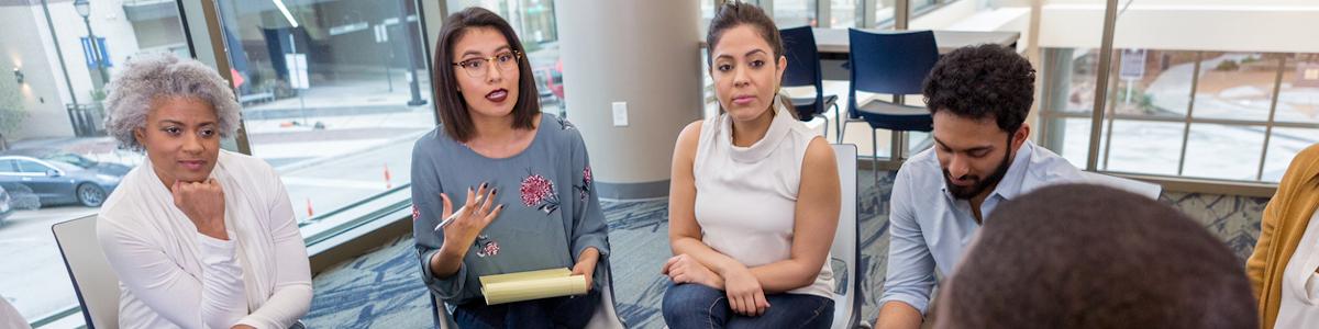 Counselor providing group therapy to patients