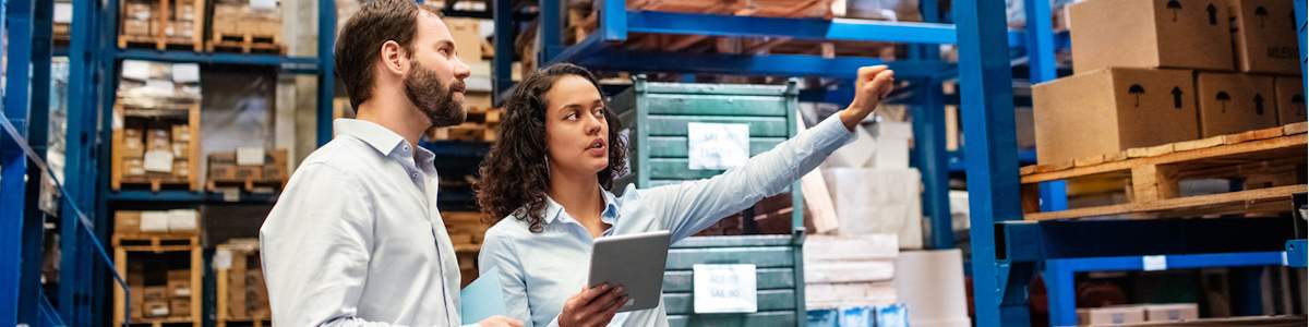 Business professionals going over inventory management in a warehouse