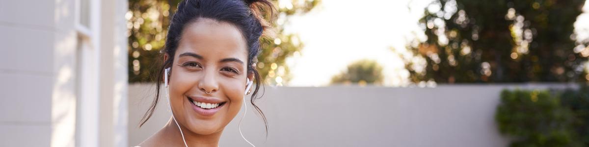 Women outside with headphones about to go jogging